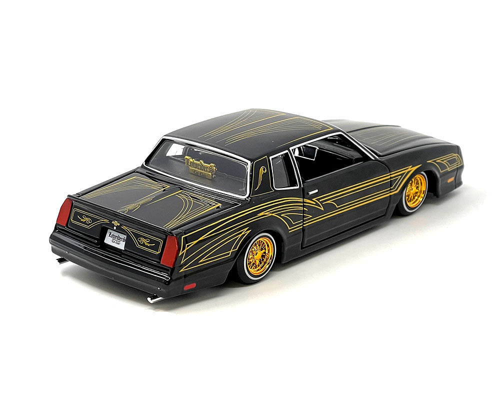 1986 Chevrolet Monte Carlo SS Lowrider Black Metallic with Gold Graphics and Wheels “Lowriders” Series 1/24 Diecast Model Car by Maisto