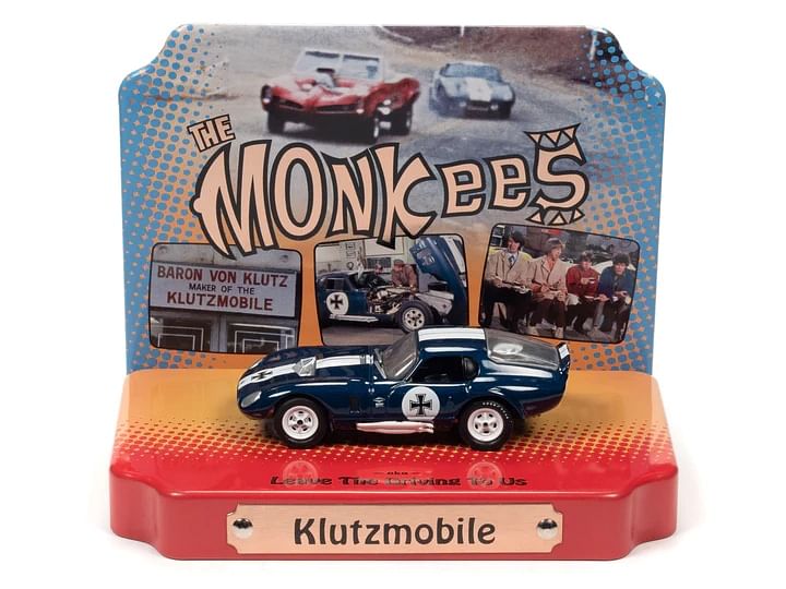 Shelby Cobra Daytona “Klutzmobile” Blue Metallic with White Stripes “The Monkees” with Collectible Tin Display “Silver Screen Machines” Series 1/64 Diecast Model Car by Johnny Lightning